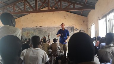 Education Volunteer teaching in a classroom.