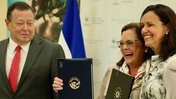 Peace Corps Director Carol Spahn signs the reestablishment of the Peace Corps in El Salvador.