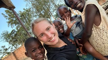A Volunteer with neighborhood children in Uganda