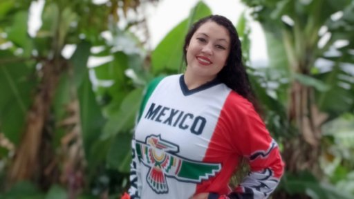 Female Mexican American Peace Corps Volunteer poses in green foliage of Jamaica in Mexican National Football Team Jersey