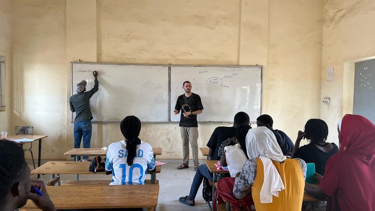 Holden supports an English club for Senegalese students.