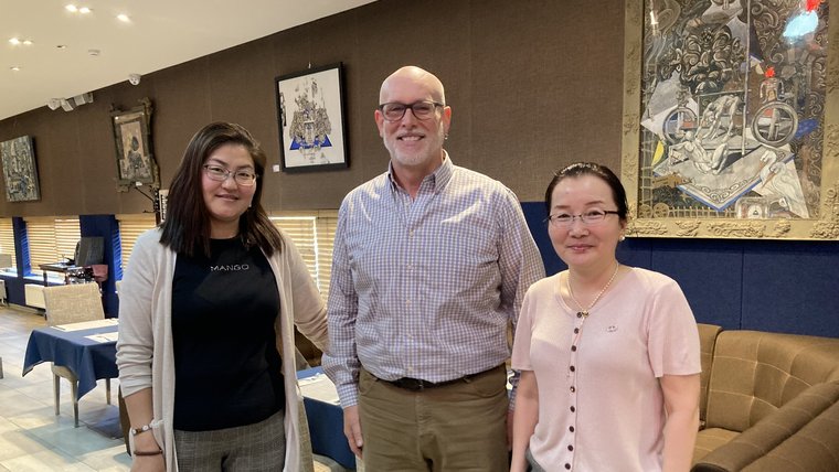 PCV John L stands with two Mongolian professors.