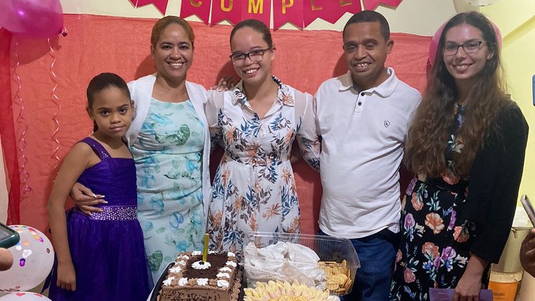 Kelcey's host family gathers around a cake in honor of her host sister's 14th birthday.
