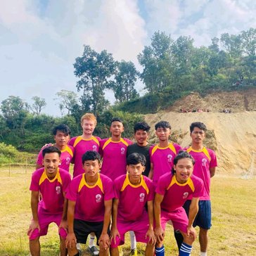 Michael enjoys playing soccer with community members in Nepal.
