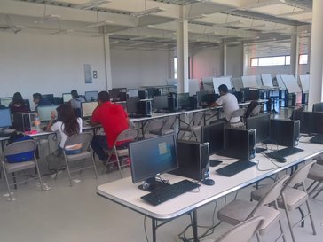 Several rows of desks with computers.
