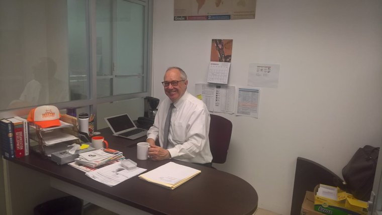 Person siting in desk in front of computer