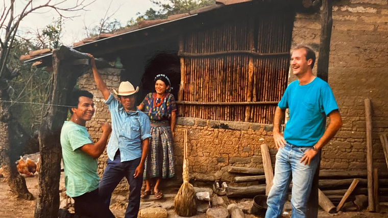 A Peace Corps Volunteer in Guatemala chats with community members.