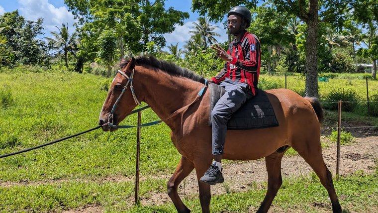 Gloire completes safety training for horse-riding in Fiji.