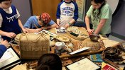 students examine objects from Tonga