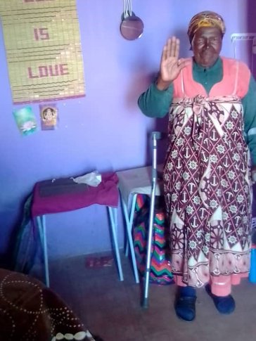 A grandma waves to the camera.