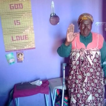 A grandma waves to the camera.