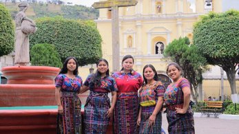 Four women stand in front of an unknown landmark in Guatemala