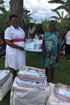 Health Worker Distributes mosquito net to expecting mother
