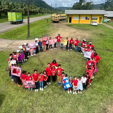 Primary students form themselves into a heart to celebrate Valentine’s Day in Belize.