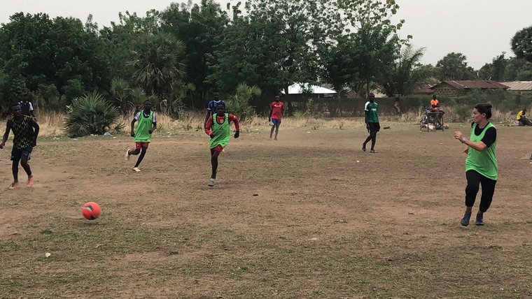 PCV playing soccer with community members