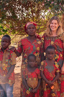 PCV and host family in a Togolese dress