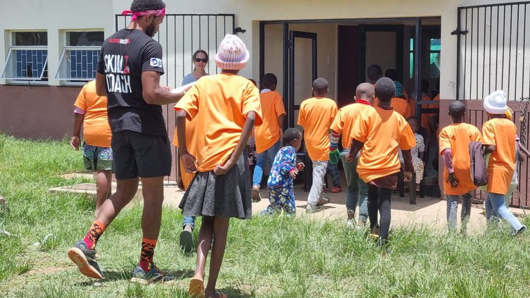 A group of young people walking towards a youth facility