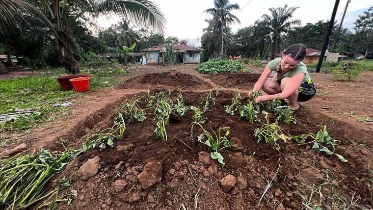 Volunteer Dee enjoys growing food in the community garden during her free time in Liberia.