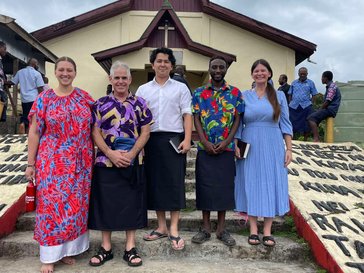 Volunteers take a group photo after church