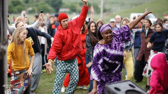 Carole Anne Reid dances with a group