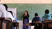 Fiorella at the front of the classroom teaching a lesson on English