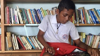 child reading in a library
