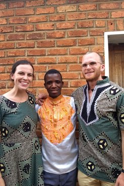 Two Volunteers and their counterpart smile together for a photo