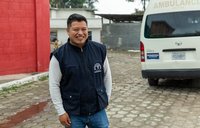 Miguel, a nurse in Guatemala, smiles in a portrait.