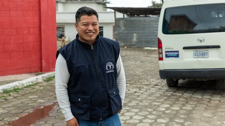 Miguel, a nurse in Guatemala, smiles in a portrait.