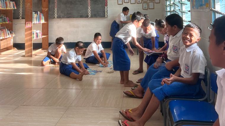 Kids read and work on puzzles in the school library in Samoa.