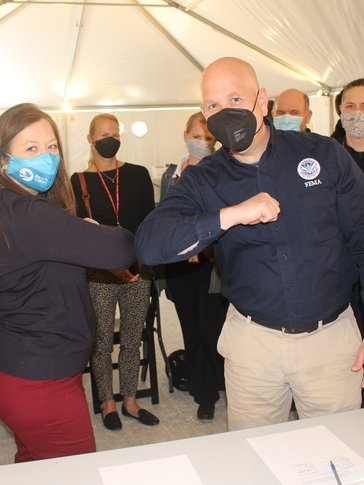 Two people elbowing.