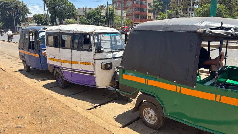 Tuk-tuks lined up for business in Kenya.