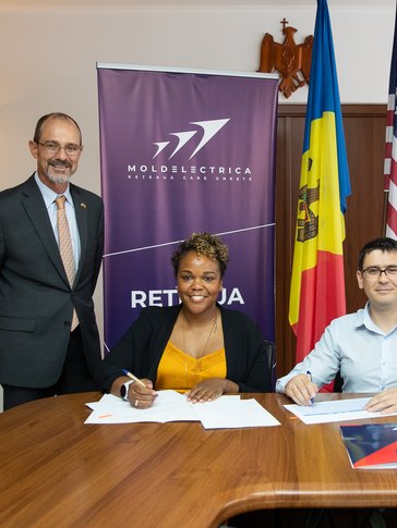 Larcus participates in a signing ceremony for an initiative to improve Moldova’s transmission system infrastructure.