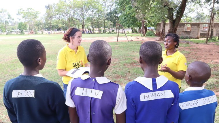 HIV prevention awareness session for students conducted by a volunteer and the counterpart