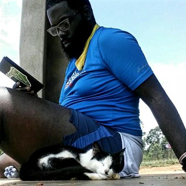 Life on the homestead consists of reading outside next to the cat after a good morning run through the community.