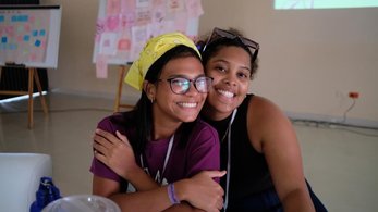Two Camp GLOW participants smile