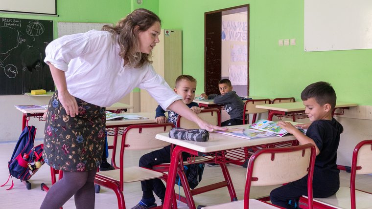 A Volunteer works with students in Albania.