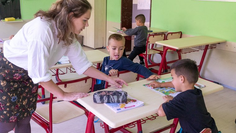 An Education Volunteer teaches students in Kosovo.