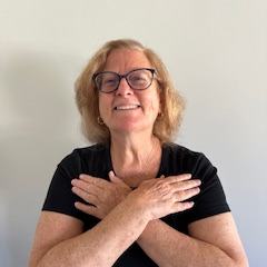 A woman crosses her arms across her chest