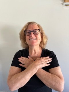 A woman crosses her arms across her chest