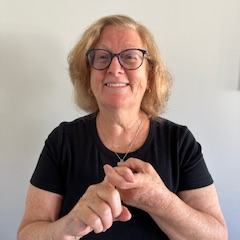 A woman interlocks her two index fingers