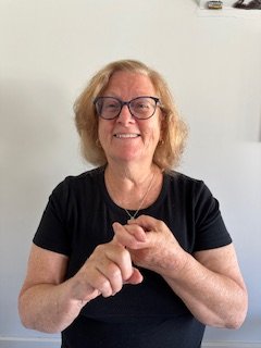 A woman interlocks her two index fingers