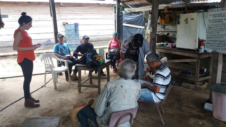 Initiating the Community Savings Group after a hard days work on the crops.
