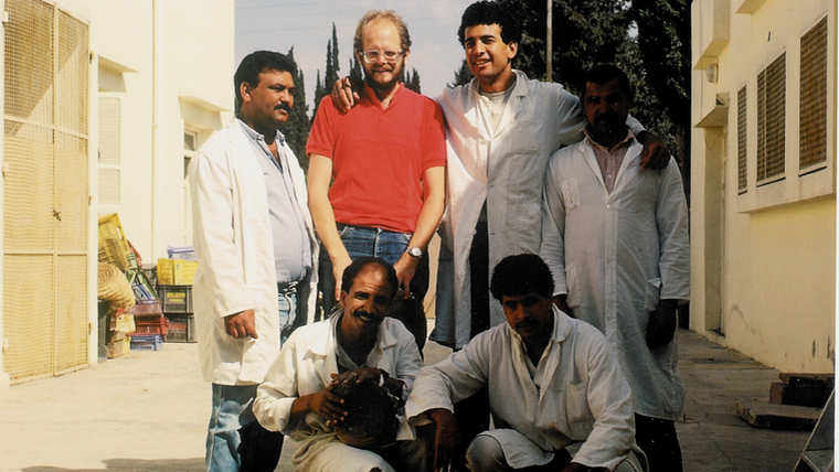 A group and Lynn pose for a photo