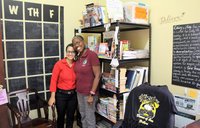 Two people standing and smiling