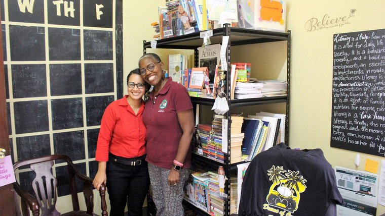 Two people standing and smiling