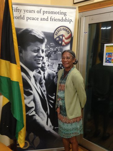 Person standing in front of JFK Peace Corps Sign