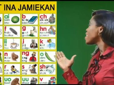 A woman shows the Jamaican alphabet