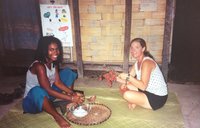 James and PCV in Madagascar collecting coconut flesh.