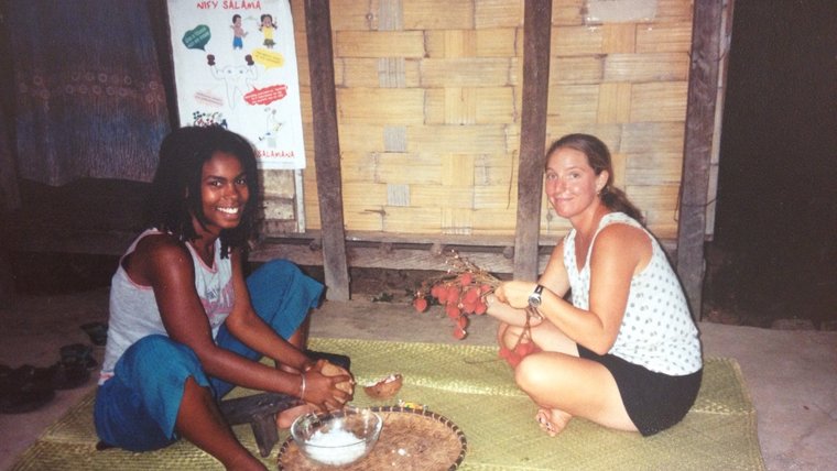 James and PCV in Madagascar collecting coconut flesh.